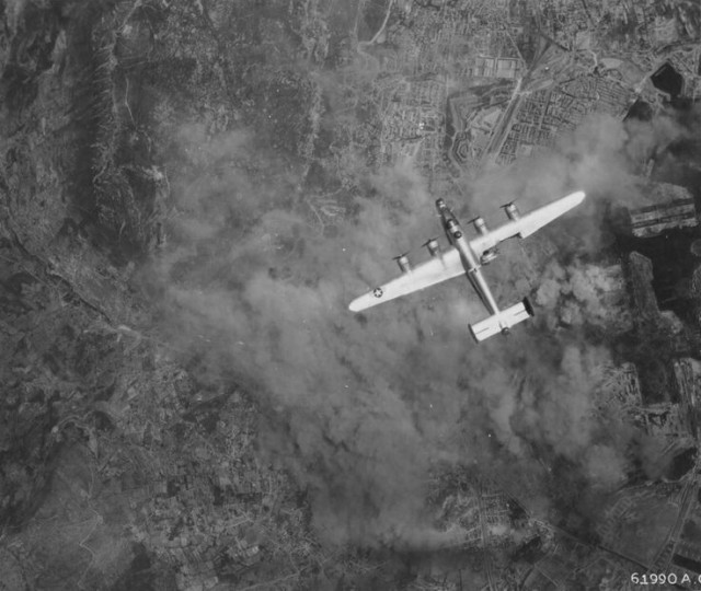 A damaged B-24 Liberator from the 376th American bombardment in flight over Toulon 1944.
