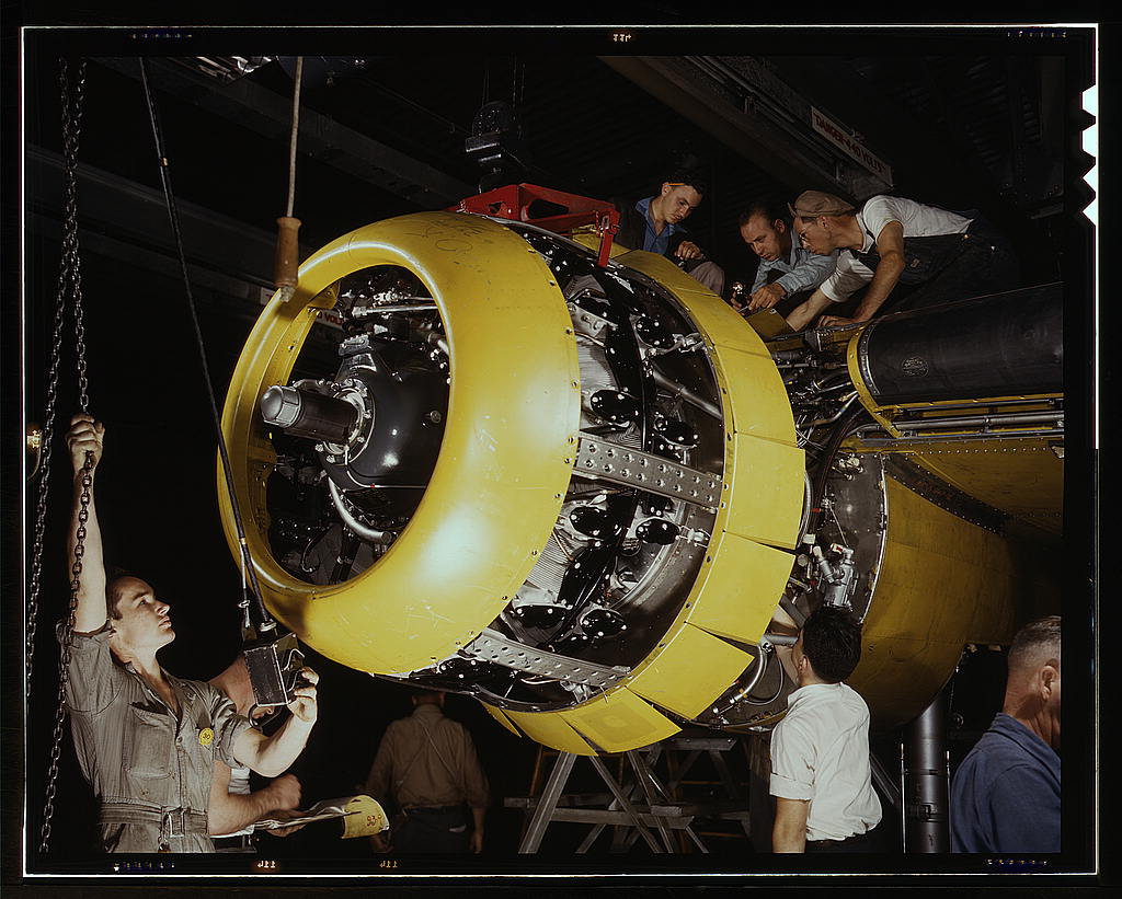 Mounting motor on a Fairfax B-25 bomber, at North American Aviation, Inc., plant in Inglewood, Calif.